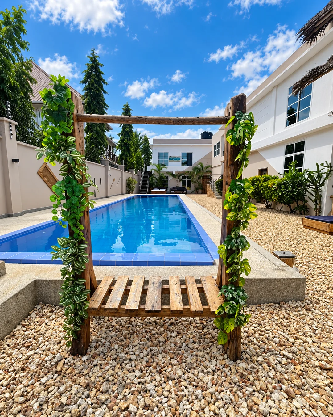VICK Boutique Hotel outdoor swimming pool surrounded by tropical plants