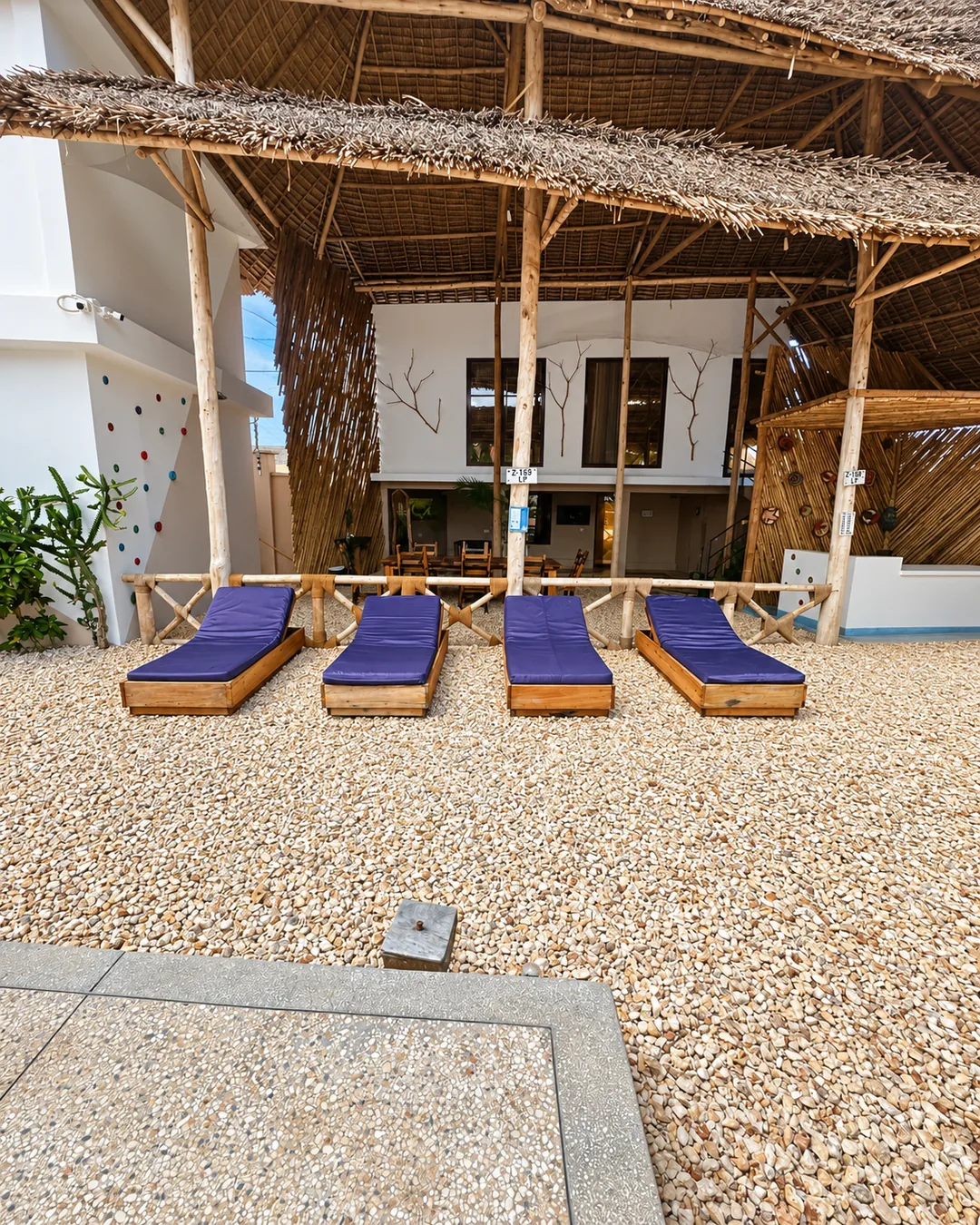 Sun loungers beneath the shaded open-air terrace at VICK Boutique Hotel